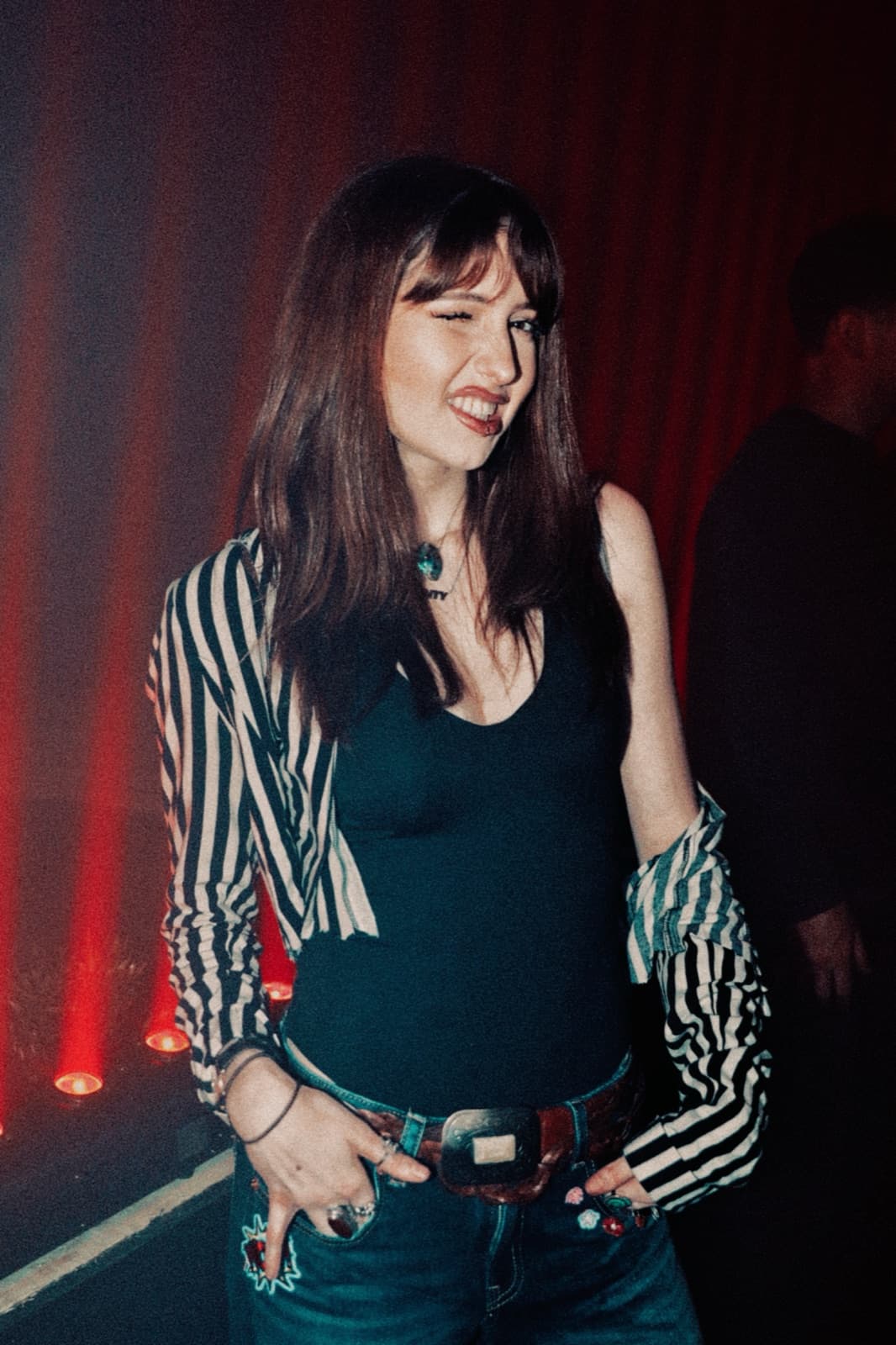 Portrait of a smiling dancer against a red curtain